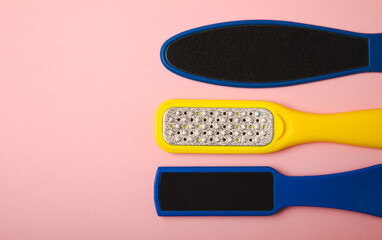 Pedicure tools.Pumice stone and foot file on a pink background. Close-up. FLAT LAY. Space for text,...