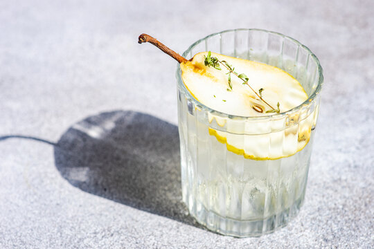Pear vodka and tonic with fresh pear and thyme