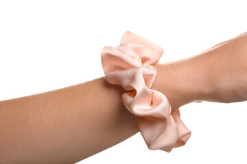 Closeup view of female hand with silk scrunchy on white background