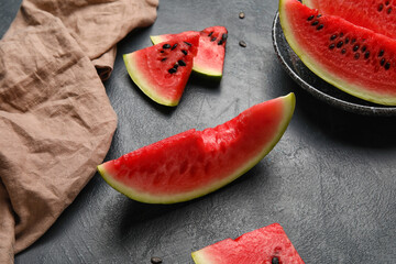 Slices of watermelon and napkin on dark background