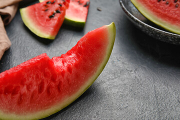 Slice of watermelon on dark background, closeup