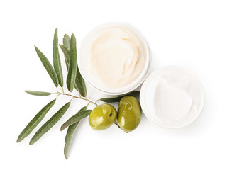 Fototapeta na wymiar Jars of cream with green olives and plant branch on white background