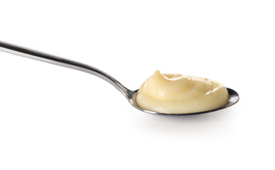 Spoon with tasty vanilla pudding on white background