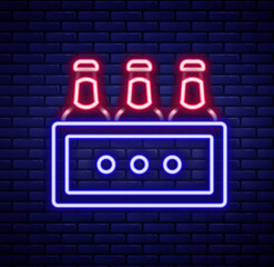 Obraz premium Glowing neon line Pack of beer bottles icon isolated on brick wall background. Wooden box and beer bottles. Case crate beer box sign. Colorful outline concept. Vector