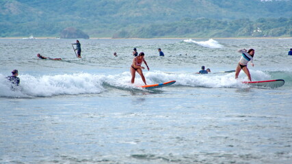 Surfer on the beach in Tamarindo, Costa Rica