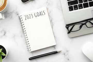 Note book with 2023 goals text on it to apply new year resolutions and plan.