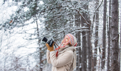 Capturing winter. Take stunning winter photos. Winter hobby. Woman photographer professional camera. Inspiration create something special. Girl with vintage camera in snowy nature. Traveling concept