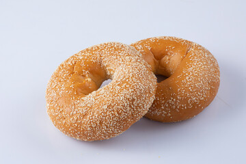 Traditional American donuts with chocolate and pink icing and sprinkles isolated on a white background. Close-up.Donuts with sprinkles flying over white background.