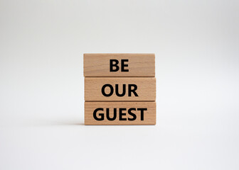Be our guest symbol. Concept word Be our guest on wooden blocks. Beautiful white background. Business and Be our guest concept. Copy space