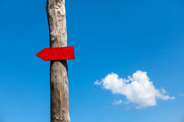 Direction wooden arrow . Red arrow at signpost
