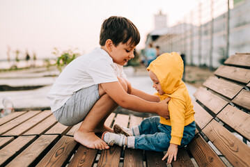 Kids beautiful siblings. Faces of wonderful two children, young cute sister and brother, playing together on outdoors. Children concept.