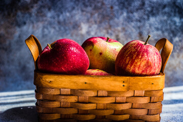 Close-up of a basket of red apples on a table
