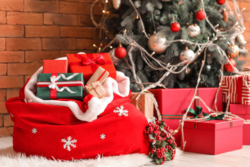 Santa bag with presents and rowan wreath in living room on Christmas eve