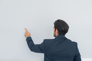Portrait of cheerful businessman handsome turn back pointing on empty blank copy-space isolate grey background