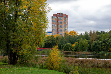 Multi-storey house on the embankment in autumn