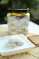 Putri salju cookie is a kind of kue kering from Malaysia which is crescent-shaped and coated with powdered sugar covered like snow. View with copy space.