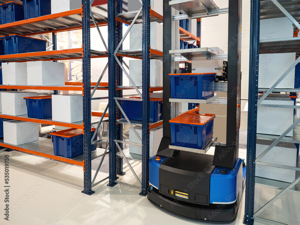 Poster automated warehouse processes. modern warehouse with automated equipment. robot picks up boxes from 