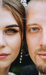 Close-up half faces of a stylish, young groom and a beautiful bride with a diadem on their heads. Wedding photography, portrait.