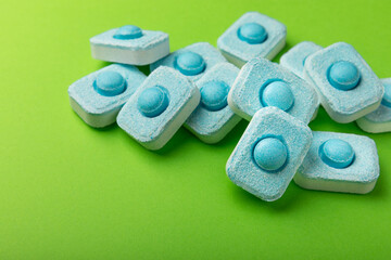 Water softener tablets on green background
.FLAT LAY. Place for text.Space for copy.Top view. Close-up
