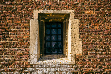 Fototapeta na wymiar Stain Glass Window against a brick wall