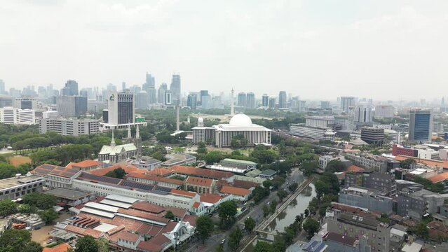 Aerial view clip of National Monument as known as Monas, and the Masjid Istiqlal, the biggest Mosque, located in Jakarta, the capital city of Indonesia, 4K resolution