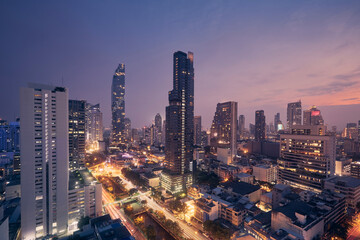 Night view of urban skyline. Downtown with skyscrapers and modern architecture. Bangkok, Thailand. - obrazy, fototapety, plakaty