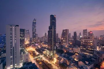 Fotobehang Night view of urban skyline. Downtown with skyscrapers and modern architecture. Bangkok, Thailand. © Chalabala