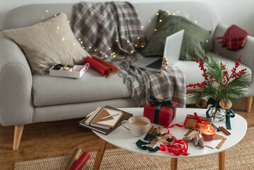 Packing Christmas gifts. View of the apartment in a mess of preparing for Christmas.