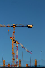 yellow construction crane on a deep blue background