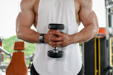 Close-up bodybuilder, Muscular bodybuilder man weight lifting or pull up with a dumbbell in gymnasium, Fitness execute exercising building muscle or bodybuilding concept.