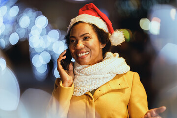 Black Woman Using Smartphone In The City At Christmas Time