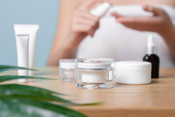 Close-up of Skincare facial cream products many various kinds on the wooden table with green leaf, Skincare and facial clean with various products, product selection, safety skincare product