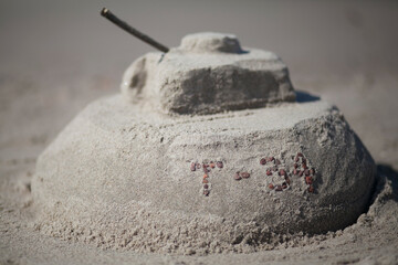 t-34 tank made of sand on the beach