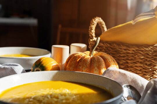 Bowl of homemade creamy pumpkin soup with cheese garnish