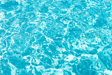 Background of blue water in swimming pool with sun reflection, ripple water wave in pool. Clear water background.