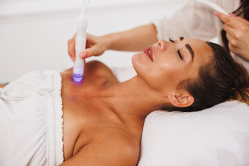 Beauty Therapist Performing Hydrafacial Procedure On Woman