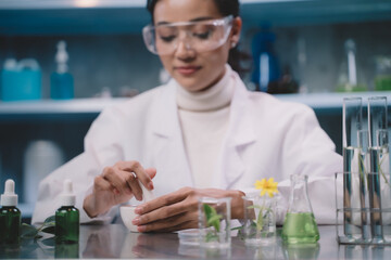 Young researcher is grind the powdered research into grinding cup in the laboratory. women are...