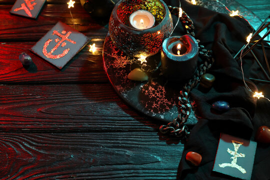 Cards with symbols and magic attributes on dark wooden table