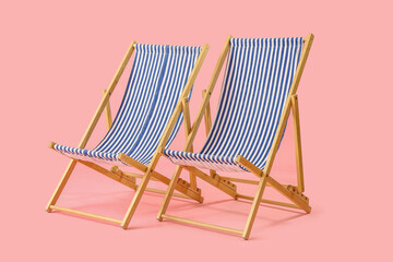 Beach deck chairs on pink background