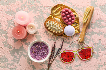 Set of bath accessories with burning candles on grunge background
