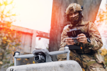 Modern army soldiers using aerial drone for artillery guidance and scouting view enemy positions in military operation