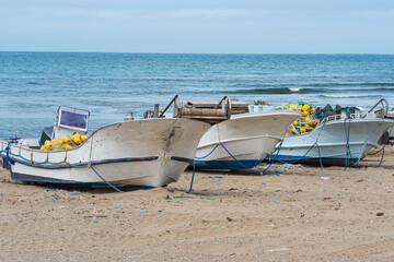 Fototapeta premium small fishing boats with a net on boards on the seashore