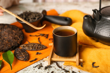 Cup of hot puer tea on table, closeup