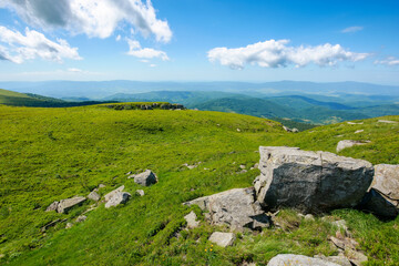 Fototapeta na wymiar carpathian mountain summer landscape. green hills and stones on a sunny day with fluffy clouds. wonderful scenery of mnt runa