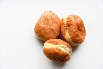 Delicious buns with jam on a white background. Sweet doughnuts with stuffing close-up.