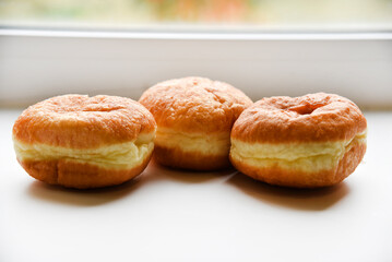 Delicious buns with jam on a white background. Sweet doughnuts with stuffing close-up.