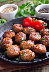 Roasted meatballs in frying pan