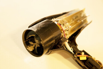 broken, burnt hair dryer. the hair dryer burned out due to dust and hair.
