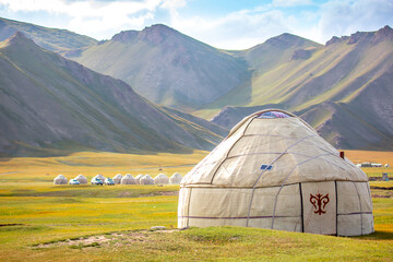 Yurt. National old house of the peoples of Kyrgyzstan and Asian countries. national housing. Yurts on the background of green meadows and highlands. Yurt camp for tourists.