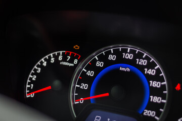 Fototapeta premium Modern car interior. Car dashboard. Engine system. Automobile speedometer. Modern transportation. Auto panel and steering wheel. Speed measure. Illuminated car dashboard.